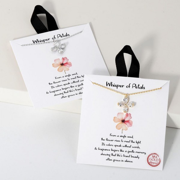 Dainty Chain Link Necklace Featuring Cubic Zirconia Flower Pendant					
					
- Approximately 16" L					
- Extender 2" L					
- Hypoallergenic Brass Base					
- 18K Gold Dipped					
- Card: "From a single seed, the flower rises to meet the light. Its colors speak without words, its fragrance lingers like a gentle memory, showing that life's truest beauty often grows in silence."					