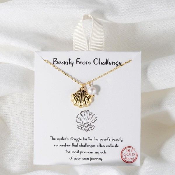 Dainty Chain Link Necklace Featuring Metal Tone Shell & Pearl Pendant 					
						
- Approximately 16" L						
- Extender 2" L						
- Hypoallergenic Brass Base						
- 18K Gold Dipped						
- Card: "The oyster's struggle births the pearl's beauty; remember that challenges often cultivate the most precious aspects of your own journey."						