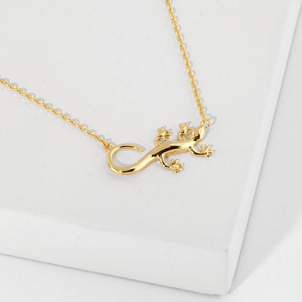 Dainty Chain Link Necklace Featuring Metal Tone Lizard Pendant 					
					
- Approximately 16" L					
- Extender 2" L					
- Hypoallergenic Brass Base					
- 18K Gold Dipped					
- Card: "In every small gecko's step is a leap of faith. Luck follows those who trust their grip, no matter how high the wall or slippery the challenge becomes."					