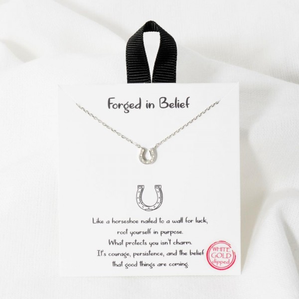 Dainty Chain Link Necklace Featuring Metal Tone Horseshoe Pendant 

- Approximately 16" L					
- Extender 2" L					
- Hypoallergenic Brass Base					
- 18K Gold Dipped					
- Card: "Like a horseshoe nailed to a wall for luck, root yourself in purpose. What protects you isn't charm. It's courage, persistence, and the belief that good things are coming."					
