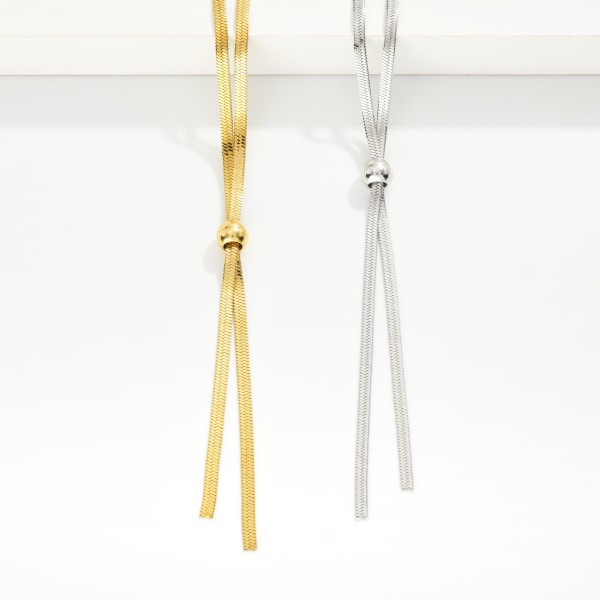 Herringbone Chain Bolo Style Necklace 

- Stainless Steel
- Water Resistant 
-  Approximately 22" L
- Extender 2" L