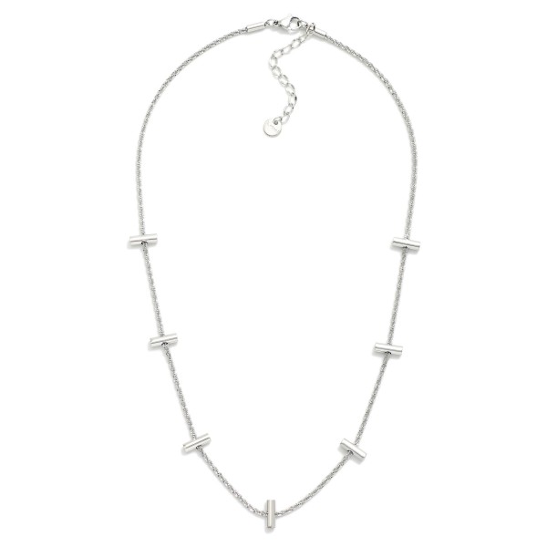 Twisted Chain Link Necklace Featuring Metal Tone Bar Stations 

- Stainless Steel
- Water Resistant
- Approximately 16" L
- Extender 2" L