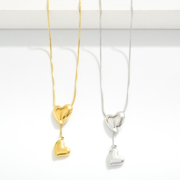 Chain Link Y Necklace Featuring Puffy Heart Details

- Stainless Steel
- Water Resistant
- Approximately 18" L