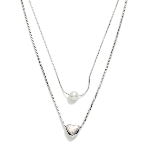 Layered Chain Link Necklace Featuring Metal Tone Puffy Heart & Pearl Pendants 

- Stainless Steel
- Water Resistant
- Approximately 16" L
- Extender 2" L