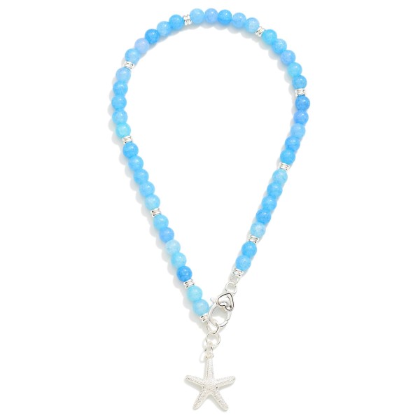 Stone Beaded Necklace Featuring  Metal Tone Textured Starfish & Clasp Pendent 

- Approximately 16" L 