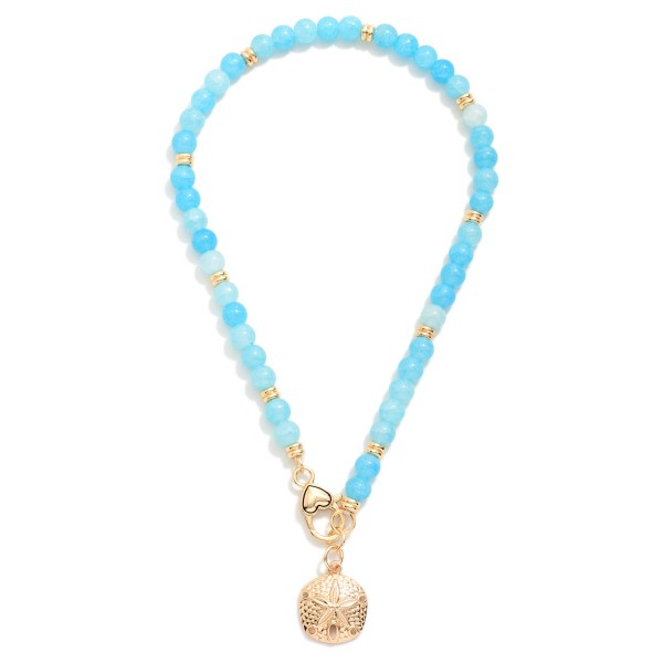 Beaded Necklace Featuring Metal Tone Sand Dollar & Clasp Pendant 

- Approximately 14" L