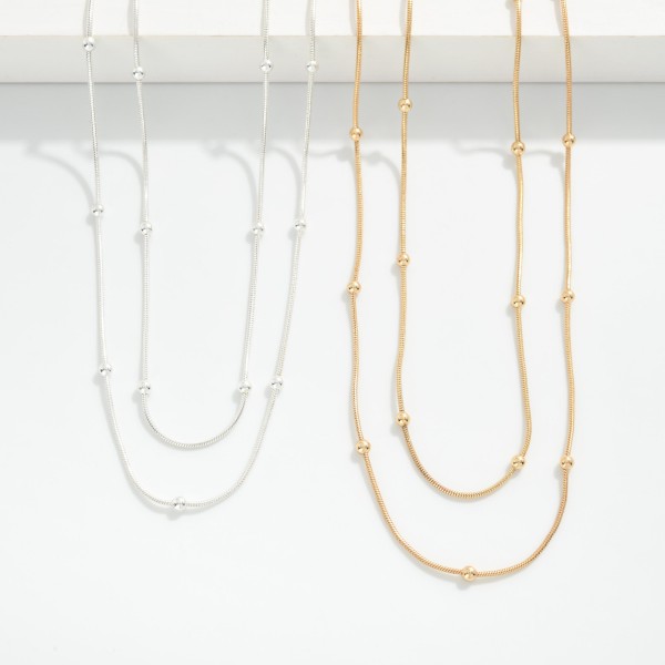 Layered Chain Link Necklace Featuring Metal Tone Ball Stations 

- Approximately 16" L
- Extender 2" L