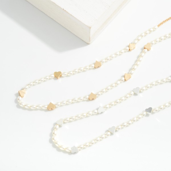 Pearl Beaded Necklace Featuring Metal Tone Heart Stations 

- Approximately 14" L
- Extender 2" L