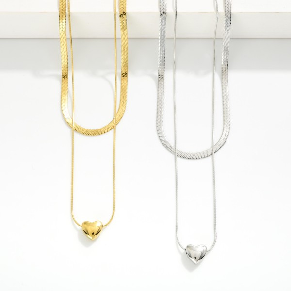 Layered Chain Link Necklace Featuring Herringbone Chain & Heart Pendant 

- Stainless Steel
- Water Resistant
- Approximately 15.5" L
- Extender 2" L