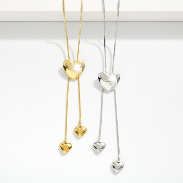 Snak Chain Bolo Style Necklace Featuring Puffy Heart Pendent 

- Stainless Steel
- Water Resistant 
- Approximately 20" L 