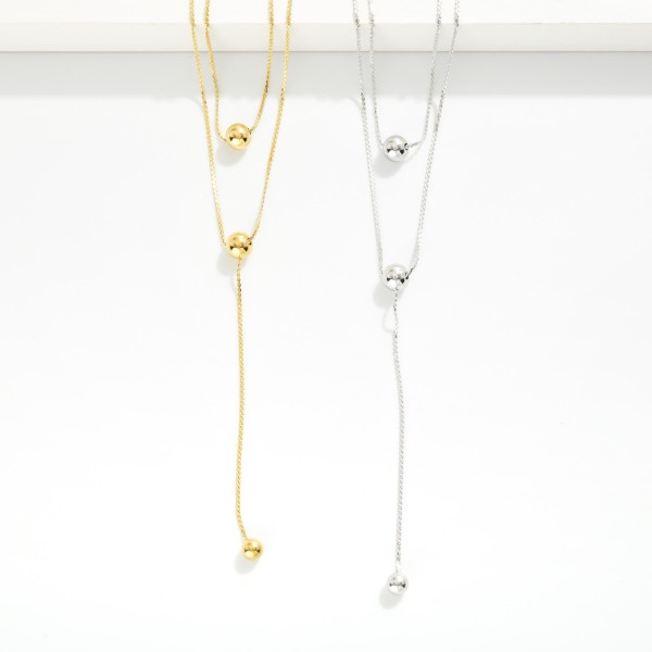 Layered S Link Necklace Featuring Metal Tone Ball Details 

- Stainless Steel
- Water Resistant
- Approximately 18" L
- Extender 2" L
