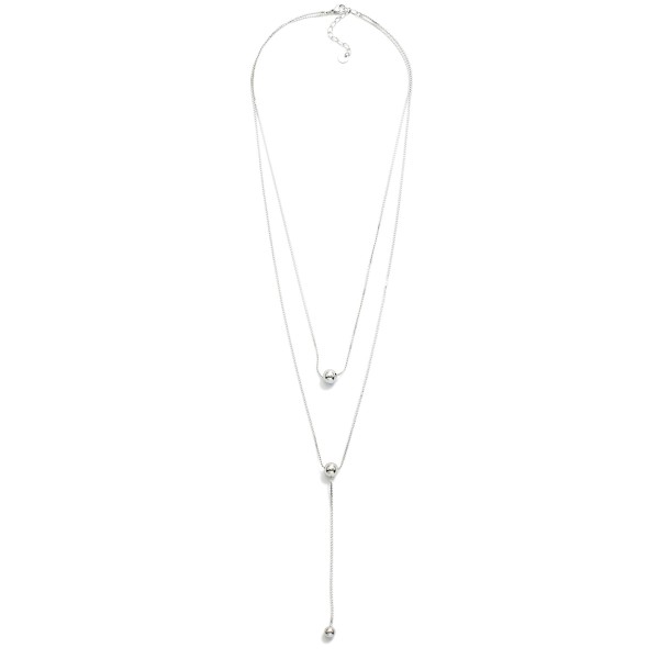 Layered S Link Necklace Featuring Metal Tone Ball Details 

- Stainless Steel
- Water Resistant
- Approximately 18" L
- Extender 2" L