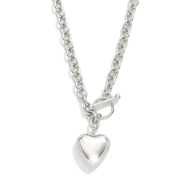 Chain Link Necklace Featuring Metal Tone Puffy Heart Pendant & Toggle Clasp

- Stainless Steel
- Water Resistant
- Approximately 15.5" L
- Extender 2" L