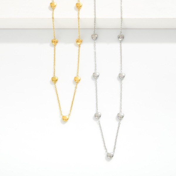 Chain Link Necklace Featuring Puffy Heart Stations  

- Stainless Steel
- Water Resistant
- Approximately 14" L
- Extender 2" L