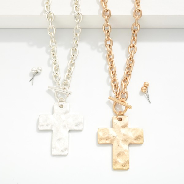 Chain Link Necklace Featuring Toggle Clasp & Hammered Metal Cross Pendant 

- Metal Tone Ball Studs Included 
- Approximately 16" L
