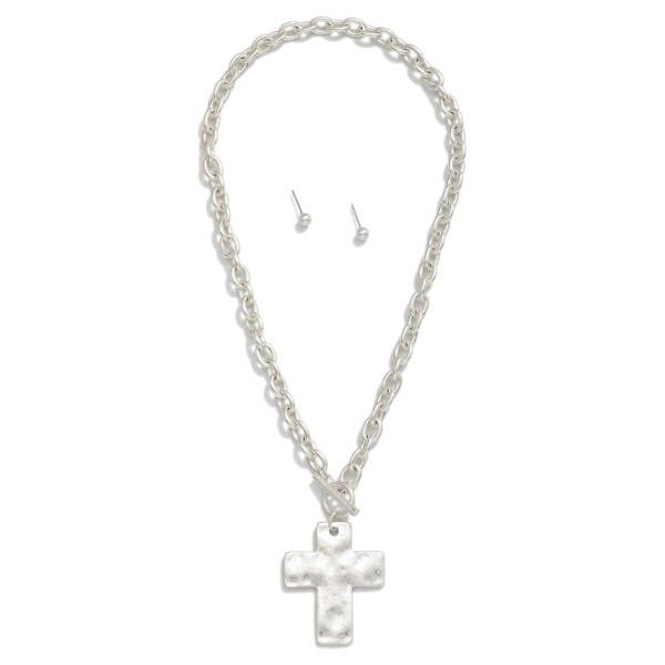 Chain Link Necklace Featuring Toggle Clasp & Hammered Metal Cross Pendant 

- Metal Tone Ball Studs Included 
- Approximately 16" L
