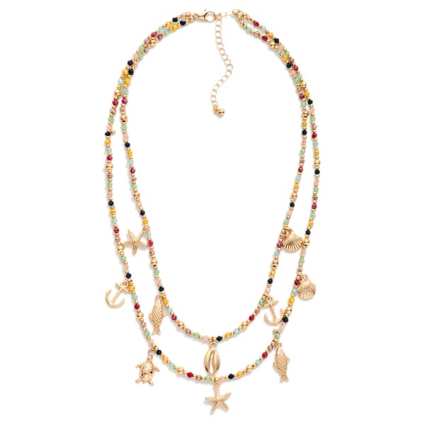 Layered Beaded Necklace Featuring Metal Beach Charms, Faceted Bead & Gold Tones 

- Approximately 18" L 
- Extender 3" L 