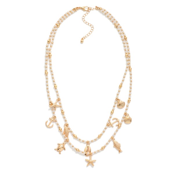 Layered Beaded Necklace Featuring Metal Beach Charms, Faceted Bead & Gold Tones 

- Approximately 18" L 
- Extender 3" L 