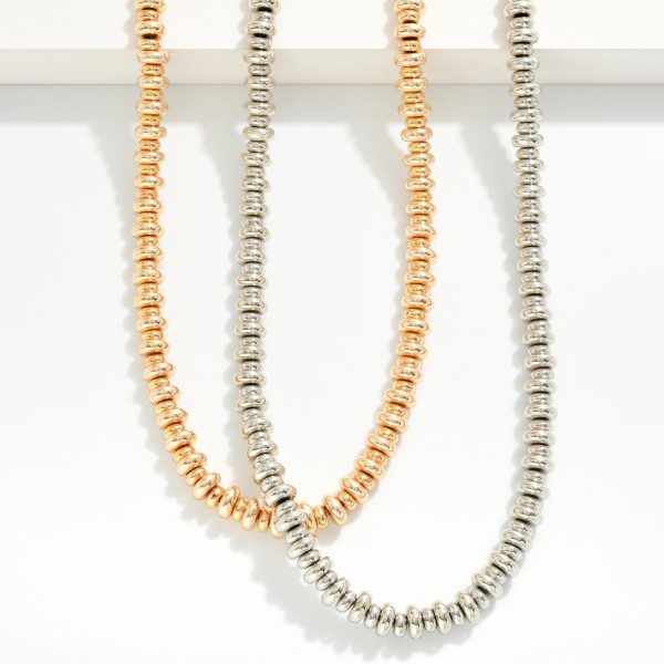 Beaded Necklace Featuring Metal Tone Disc Beads 

- Approximately 16.5" L 
- Extender 3" L 