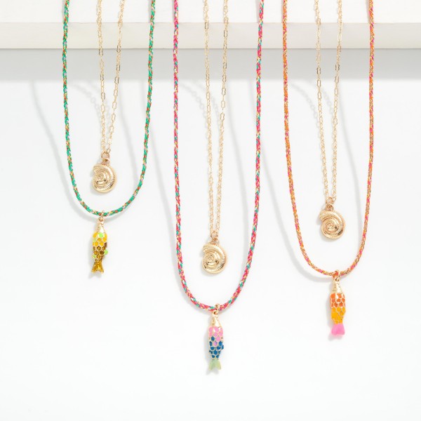 Layered Metal Tone Chain Link Necklace & Braided Yarn Tensile Necklace Featuring Shell And Fish Pendant 

- Approximately 18" L 
- Extender 3" L 