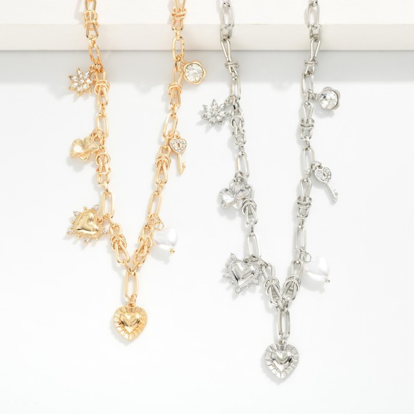 Metal Tone Paperclip Chain Link Necklace Featuring Metal Charms, Rhinstones, & Pearl 

- Approximately 16" L 
- Extender 3" L