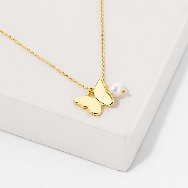 Dainty Chain Link Necklace Featuring Metal Tone Butterfly Pendant With Pearl  Accent																							
																									
- Approximately 16" L																									
- Extender 2" L																									
- Hypoallergenic Brass Base																									
- 18K Gold Dipped																									
- Card: "Be like a butterfly. Chase sunshine, land on joy, and never apologize for showing up in your brightest colors."																									
