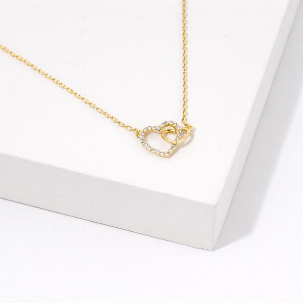 Dainty Chain Link Necklace Featuring Linked Metal Tone & Cubic Zirconia Hearts Pendant 																							
																									
- Approximately 16" L																									
- Extender 2" L																									
- Hypoallergenic Brass Base																									
- 18K Gold Dipped																									
- Card: "There's nothing stronger than a mother's love, nor more healing than the laughter and sunshine that live inside a little girl's smile."																									