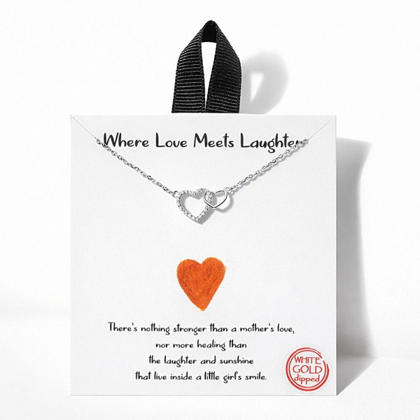 Dainty Chain Link Necklace Featuring Linked Metal Tone & Cubic Zirconia Hearts Pendant 																							
																									
- Approximately 16" L																									
- Extender 2" L																									
- Hypoallergenic Brass Base																									
- 18K Gold Dipped																									
- Card: "There's nothing stronger than a mother's love, nor more healing than the laughter and sunshine that live inside a little girl's smile."																									