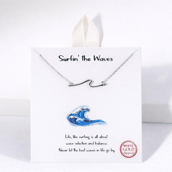 Dainty Chain Link Necklace Featuring Metal Tone Wave Pendant 				
					
- Approximately 16" L					
- Extender 2" L					
- Hypoallergenic Brass Base					
- 18K Gold Dipped					
- Card: "Life, like surfing is all about wave selection and balance. Never let the best waves in life go by."					