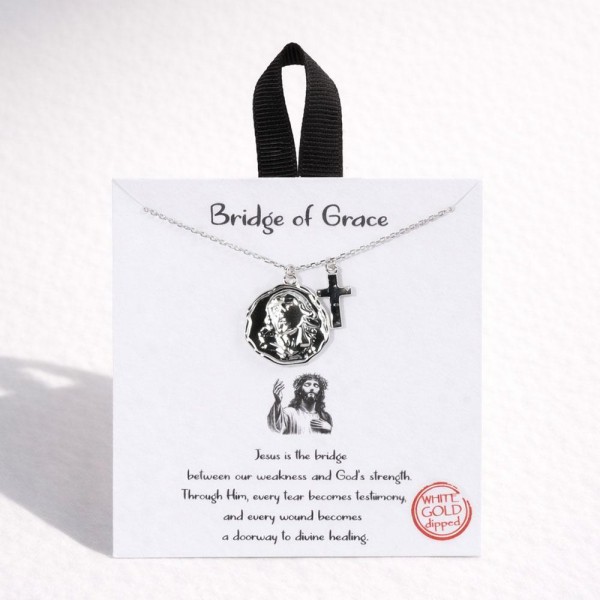 Dainty Chain Link Necklace Featuring Metal Tone Jesus Medallion & Cross Pendants 			
					
- Approximately 16" L					
- Extender 2" L					
- Hypoallergenic Brass Base					
- 18K Gold Dipped					
- Card: "Jesus is the bridge between our weakness and God's strength. Through Him, every tear becomes testimony, and every wound becomes a doorway to divine healing."					
					