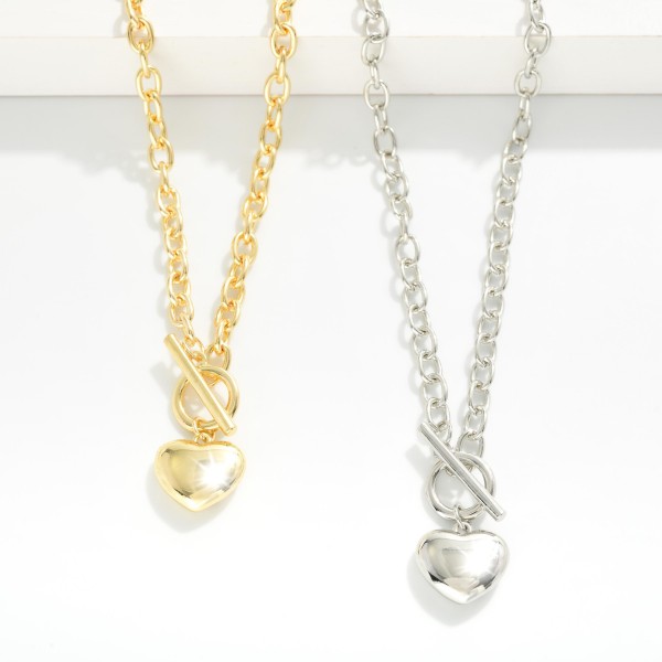 Chain Link Necklace Featuring Puffy Metal Tone Heart Pendant & Toggle Clasp 

- Gold Dipped
- Approximately 18" L
- Extender 1" L