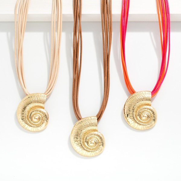 Layered Wax Cord Necklace Featuring Metal Tone Fossil Pendant 

- Approximately 16" L
- Extender 3" L