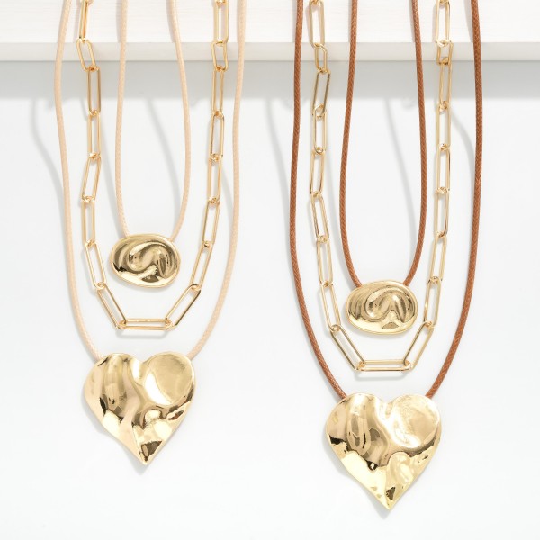 Set Of Two Chain Link & Wax Cord Necklaces Featuring Metal Tone Geometric Shape & Heart Pendants 

- Approximately 16" L
- Extender 3" L