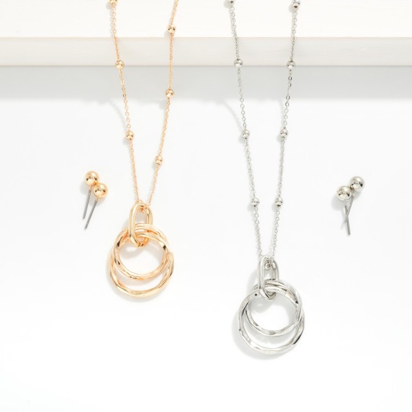 Chain Link Necklace With Metal Tone Ball Stations & Nesting Metal Tone Hoops Pendant 

- Metal Tone Ball Studs Included 
- Approximately 14" L
- Extender 3" L