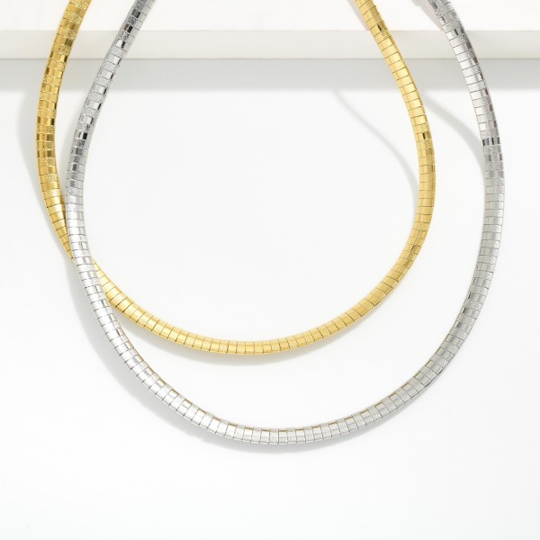 Metal Tone Flat Snake Chain Necklace Featuring Beaded Blasted Textured 

- Approximately 14" L 
- Extender 3" L 
- Stainless Steal
- Water Resistant
