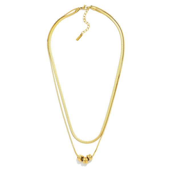 Layered Herringbone Chain Link Necklace Feating Metal Tone Beaded Disks 

- Stainless Steel 
- Approximately 16.5" L
- Extender 2" L 