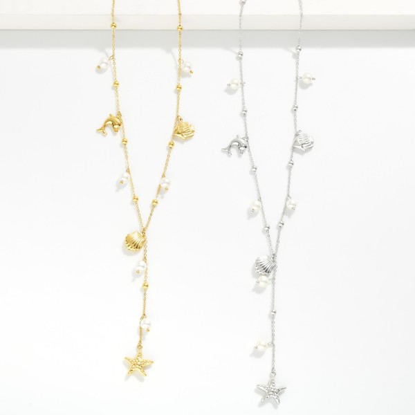 Chain Link Charm Necklace Featuring Pearls & Metal Tone Beach Charms 

- Approximately 20" L 
- Stainless Steal
- Water Resistant