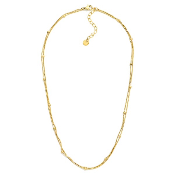 Layered Snake Chain Necklace Featuring Metal Ball Stations 

- Approximately 15" L 
- Extender 3"L 
- Stainless Steel 
- Water Resistant 