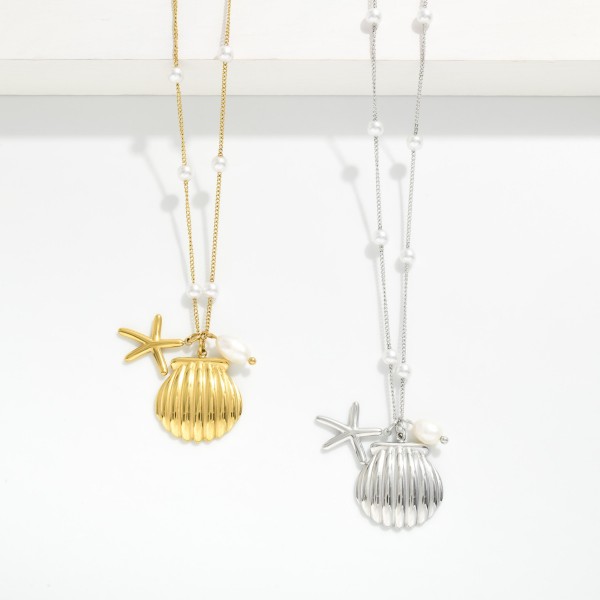Metal Tone Chain Link Necklace Featuring Pearl Stations & Shell Pendant 

- Approximately 16" L 
- Stainless Steal
- Water Resistant
