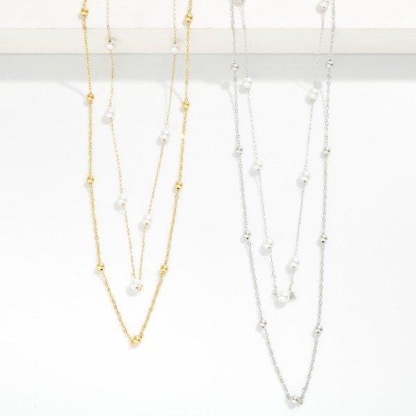 Layered Dainty Chain Link Necklace Featuring Metal Ball And Pearl Stations 

- Approximately 14" L 
- Extender 3"L 
- Stainless Steel 
- Water Resistant 