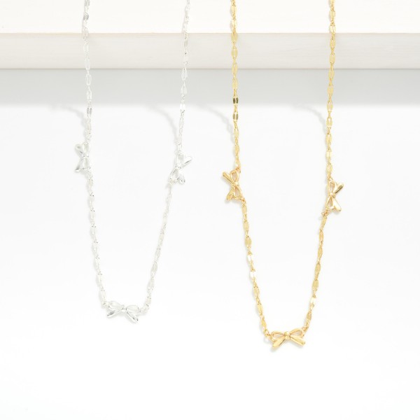 Flat Chain Link Necklace Featuring Metal Tone Bow Stations 

- Gold Dipped
- Approximately 16.5" L
- Extender 2" L