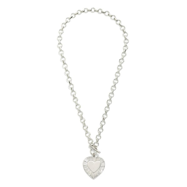 Metal Tone Circle Chain Link Necklace Featuring Heart Pendant & Toggle Clasp 

- Approximately 18" L 