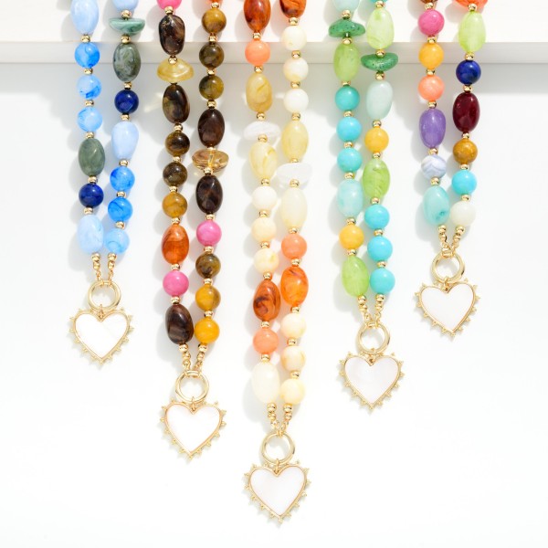 Marbled Acetate Beaded Necklace Featuring Gold Tone Beaded Stations & Heart Pendant 

- Approximately 18" L
- Extender 2" L 