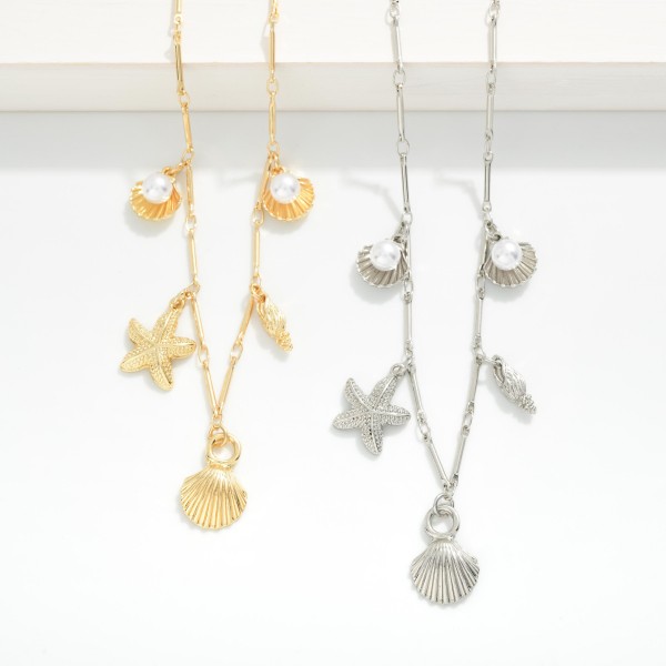 Metal Tone Bar Chain Link Necklace Featuring Beach Charms, Gold Tones, And Pearls 

- Approximately 18" L 
- Extender 2" L 