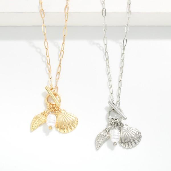 Paperclip Chain Link Necklace Featuring Metal Tone Shells, Pearl, & Toggle Clasp Pendant

- Approximately 16" L 