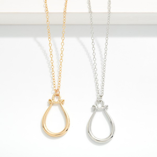 Chain Link Necklace Featuring Horsebit Pendant 

_ Approximately 22" L
- Extender 3" L