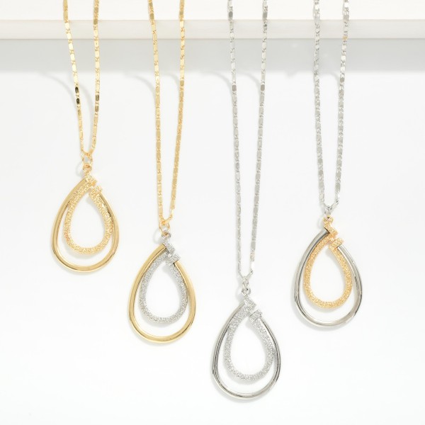 Metal Tone Chain Link Necklace Featuring Textured Nesting Teardrop Pendant  

- Approximately 20" L 
- Extender 3" L 