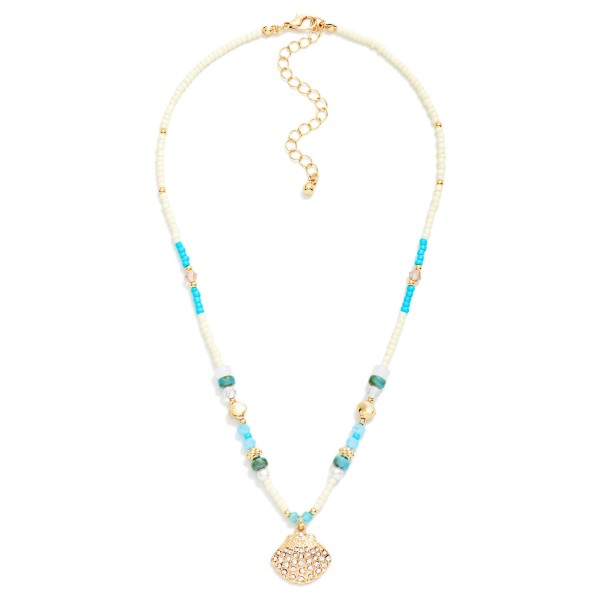Multi Bead Necklace Featuring Rhinestone Studded Metal Tone Shell Pendant 

- Approximately 14" L
- Extender 2" L
