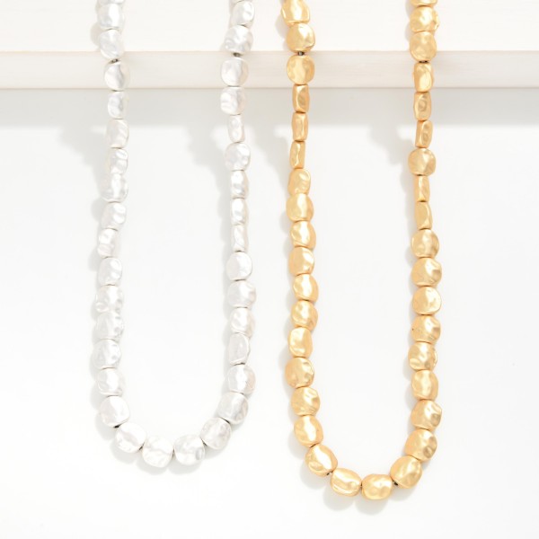 Long Hammered Metal Nugget Beaded Necklace

- Approximately 24" L
- Extender 3" L 
