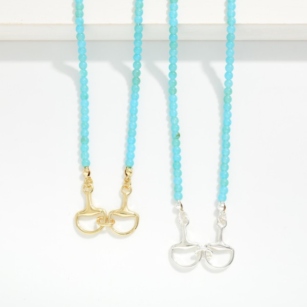 Turquoise Stone Beaded Necklace Featuring Metal Tone Stationary Horsebit Pendant 

- Gold Dipped 
- Approximately 16" L
- Extender 3" L